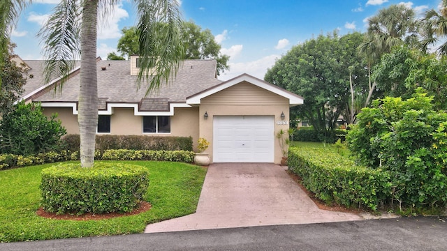 view of front of house featuring a garage and a front yard