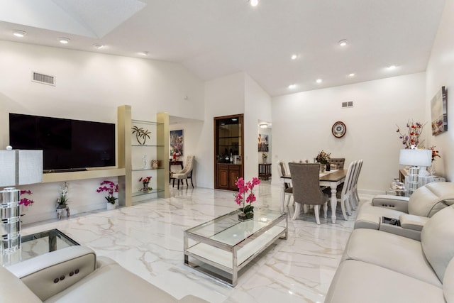 living room with high vaulted ceiling