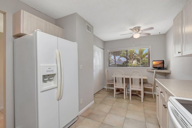 kitchen with ceiling fan, white appliances, and light tile patterned floors