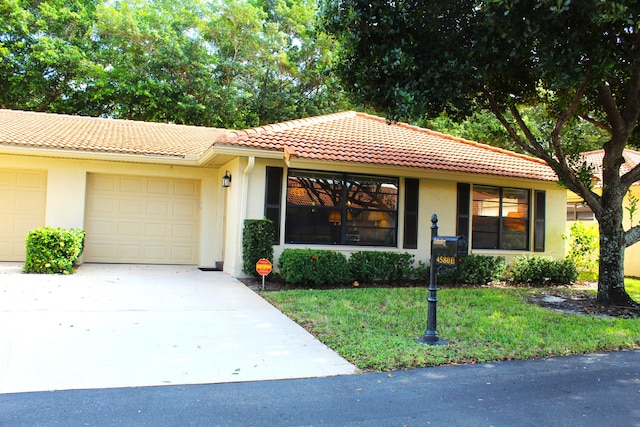 view of front of house with a front yard and a garage