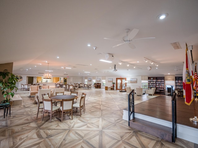 dining area featuring ceiling fan and light parquet floors