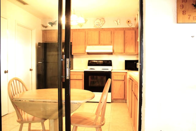 kitchen featuring light tile patterned flooring, pendant lighting, an inviting chandelier, and black appliances