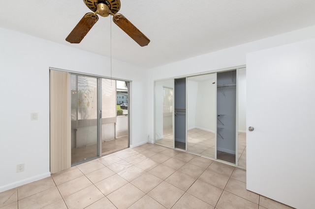 unfurnished bedroom featuring ceiling fan and light tile patterned floors