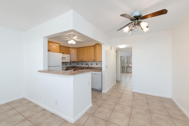 kitchen featuring white appliances, kitchen peninsula, light tile patterned floors, ceiling fan, and a textured ceiling