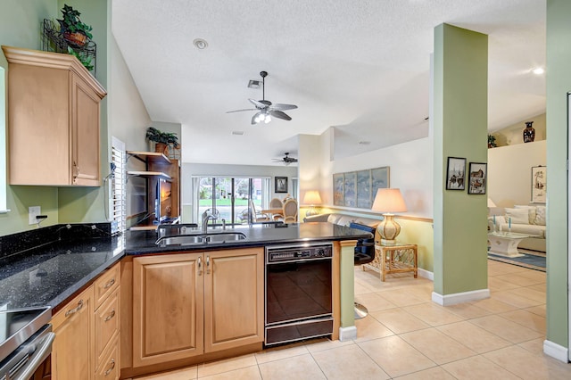 kitchen featuring sink, light tile patterned floors, lofted ceiling, and black dishwasher