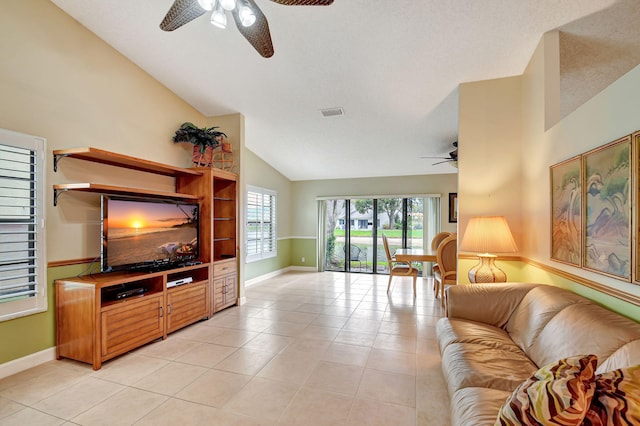 living room with light tile patterned floors, a textured ceiling, and high vaulted ceiling