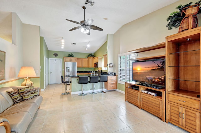 tiled living room with high vaulted ceiling, ceiling fan, and sink