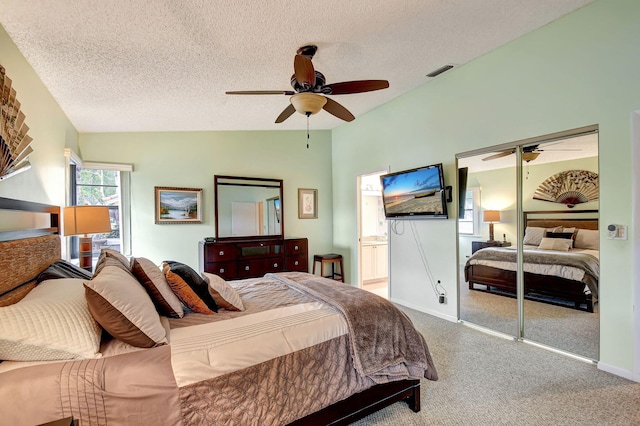 carpeted bedroom featuring a textured ceiling, ceiling fan, a closet, and lofted ceiling