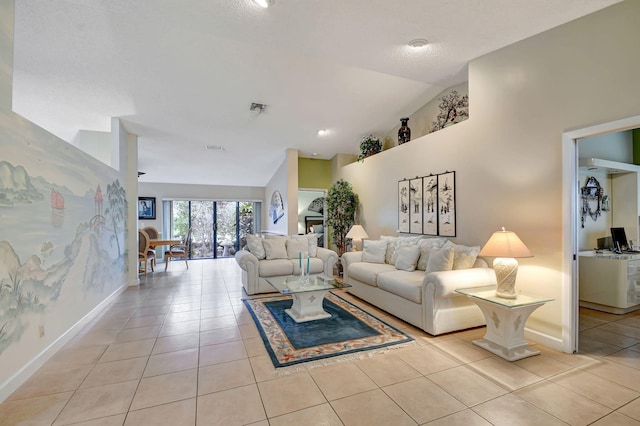 living room featuring ceiling fan, light tile patterned flooring, and high vaulted ceiling