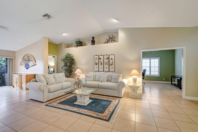 tiled living room featuring high vaulted ceiling