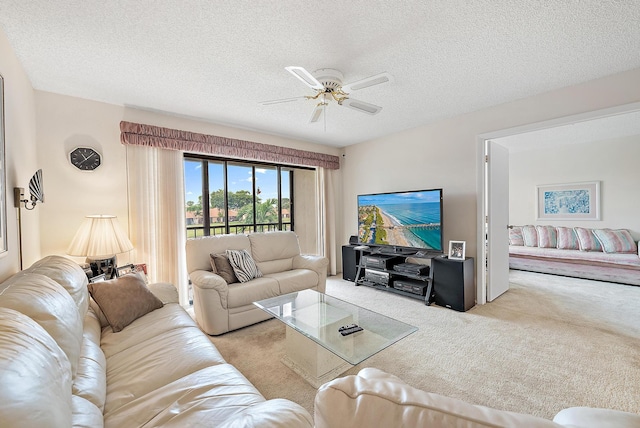 carpeted living room with a textured ceiling and ceiling fan