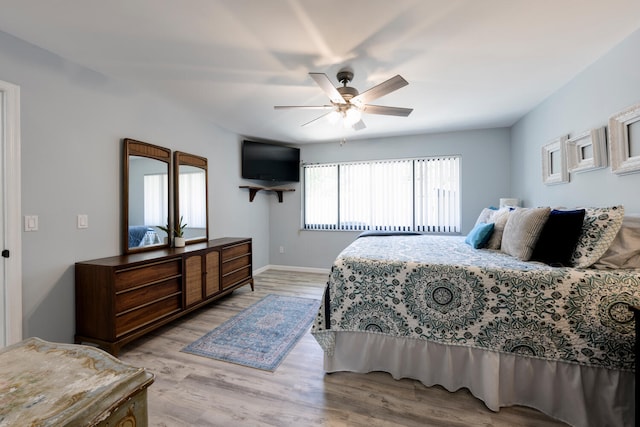 bedroom with light hardwood / wood-style flooring and ceiling fan