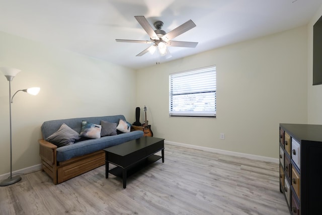 living room featuring light wood-type flooring and ceiling fan