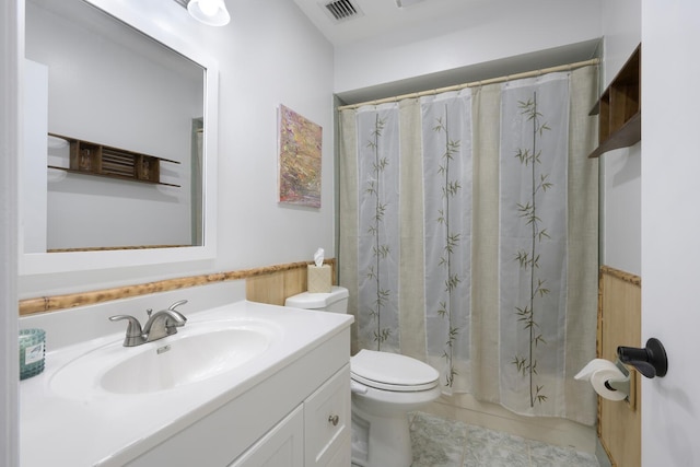 bathroom featuring tile patterned flooring, a shower with curtain, vanity, and toilet