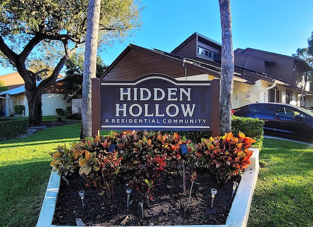 community / neighborhood sign with a lawn