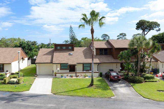 view of front facade with a garage and a front lawn