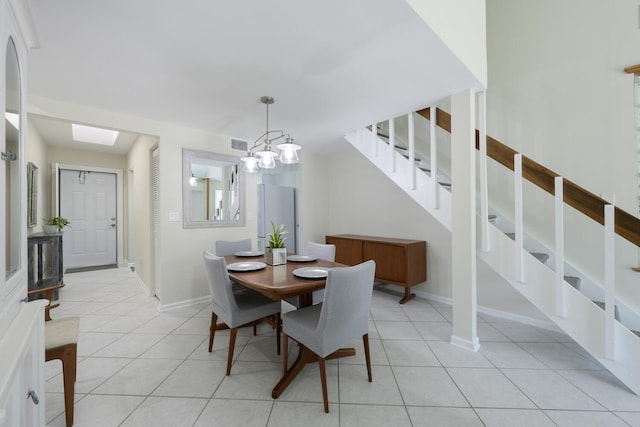 dining area with an inviting chandelier and light tile patterned flooring