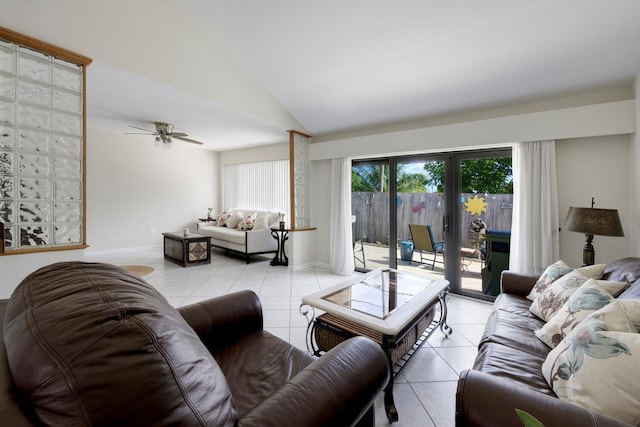 tiled living room with ceiling fan, french doors, and vaulted ceiling