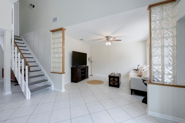 unfurnished living room with ceiling fan and light tile patterned flooring