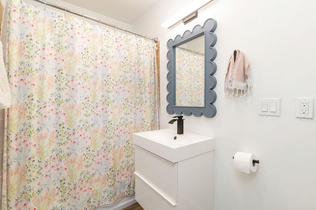 bathroom featuring curtained shower and vanity