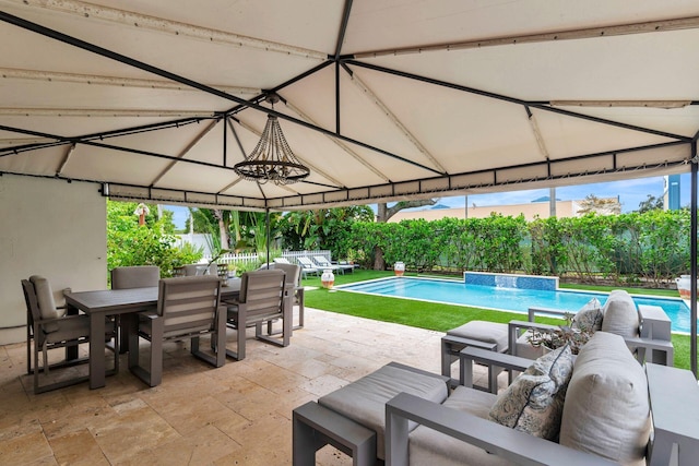 view of pool featuring pool water feature, an outdoor living space, and a patio