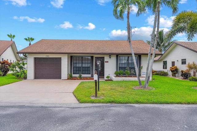 ranch-style home featuring a front lawn and a garage