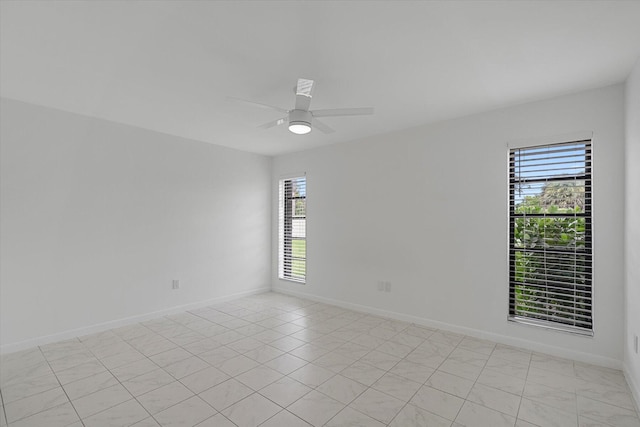 unfurnished room with ceiling fan and light tile patterned flooring