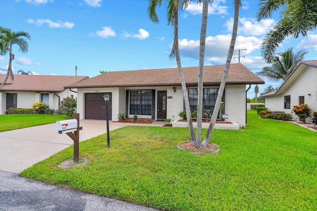 ranch-style home with a front yard and a garage