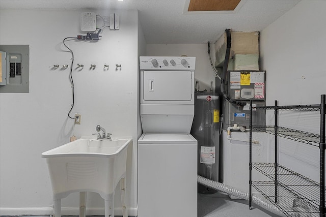 clothes washing area with sink, electric panel, stacked washer and dryer, and water heater