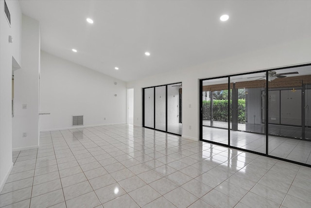 tiled spare room featuring ceiling fan and lofted ceiling