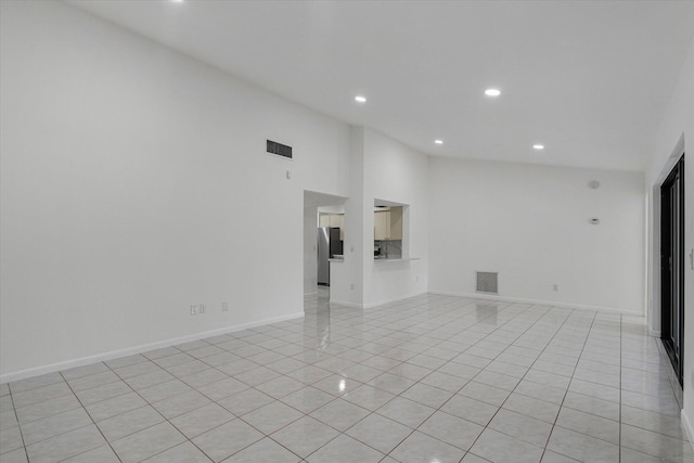 unfurnished living room featuring light tile patterned floors and a high ceiling