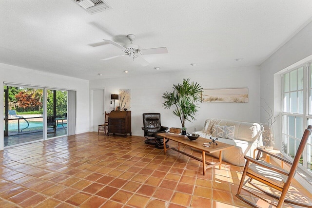 unfurnished room with ceiling fan, tile patterned flooring, and a textured ceiling