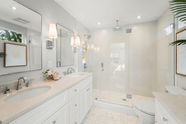 bathroom featuring toilet, tile patterned flooring, walk in shower, and vanity