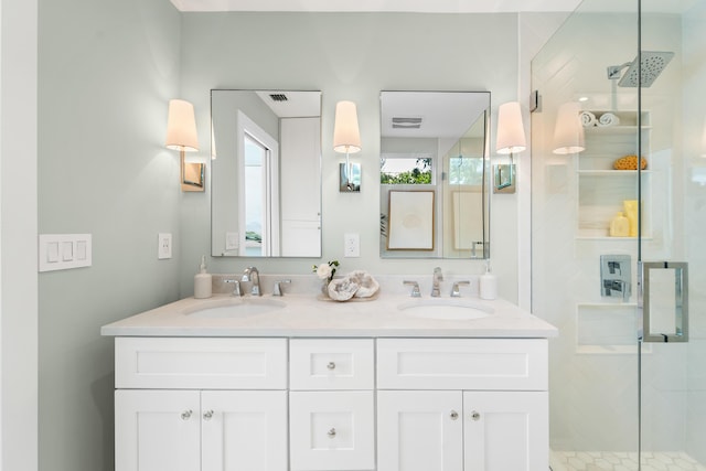 bathroom with a shower with shower door and vanity