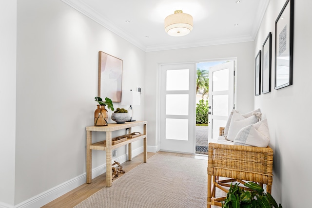 doorway with ornamental molding and hardwood / wood-style floors