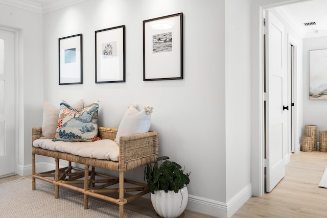 sitting room featuring light hardwood / wood-style flooring and ornamental molding