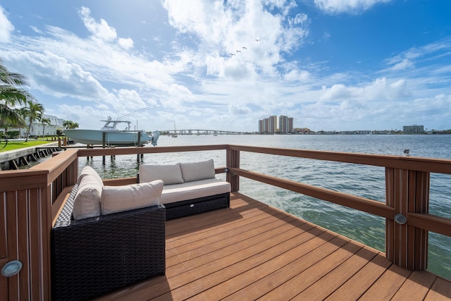 dock area featuring a water view and an outdoor living space