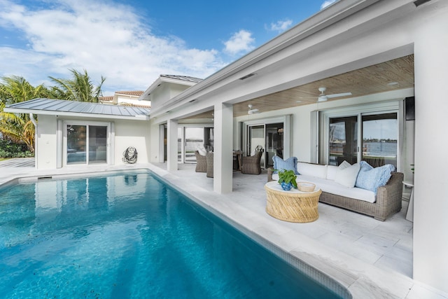 view of swimming pool with ceiling fan, an outdoor hangout area, and a patio area