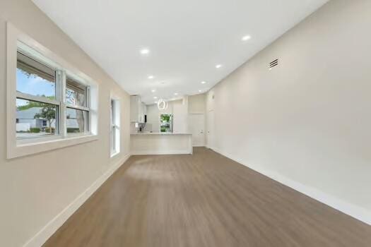 unfurnished living room with hardwood / wood-style flooring