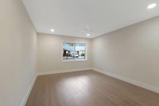 spare room with wood-type flooring