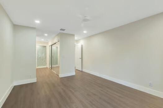 spare room with dark hardwood / wood-style floors