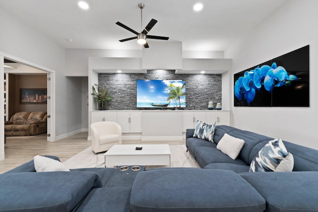 living room with ceiling fan and light hardwood / wood-style flooring