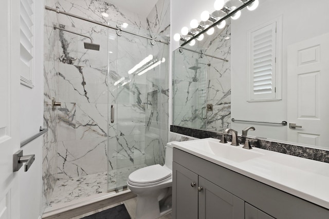 bathroom with hardwood / wood-style floors, vanity, toilet, and walk in shower