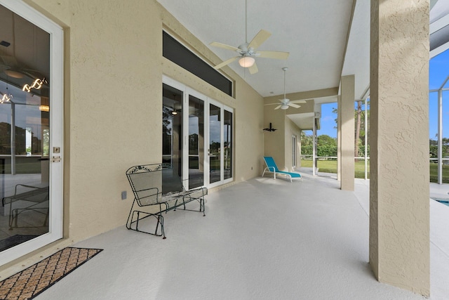 view of patio featuring ceiling fan and a lanai