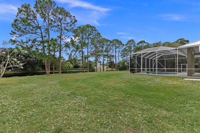 view of yard with glass enclosure