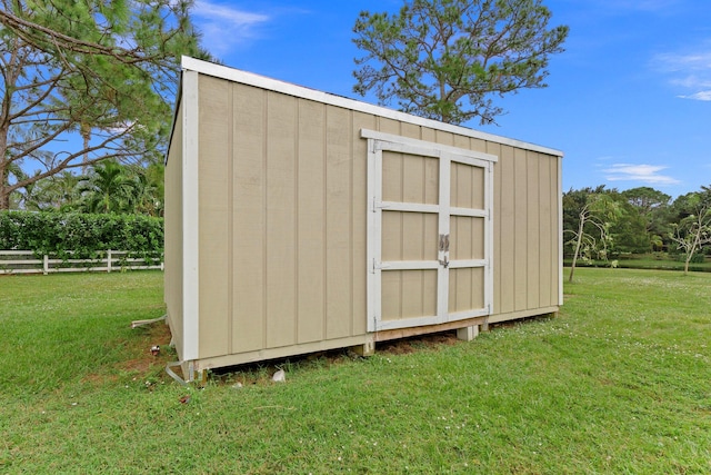 view of outdoor structure featuring a lawn