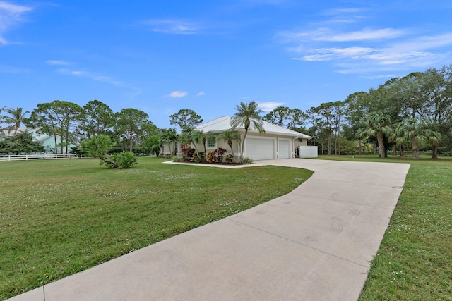 ranch-style house featuring a garage and a front lawn