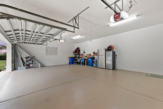 garage featuring stainless steel fridge and a garage door opener