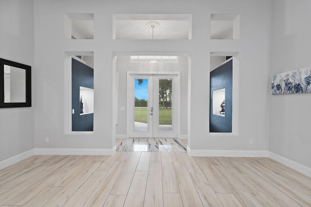 entrance foyer with light hardwood / wood-style flooring and french doors