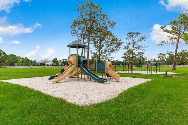 view of jungle gym featuring a lawn